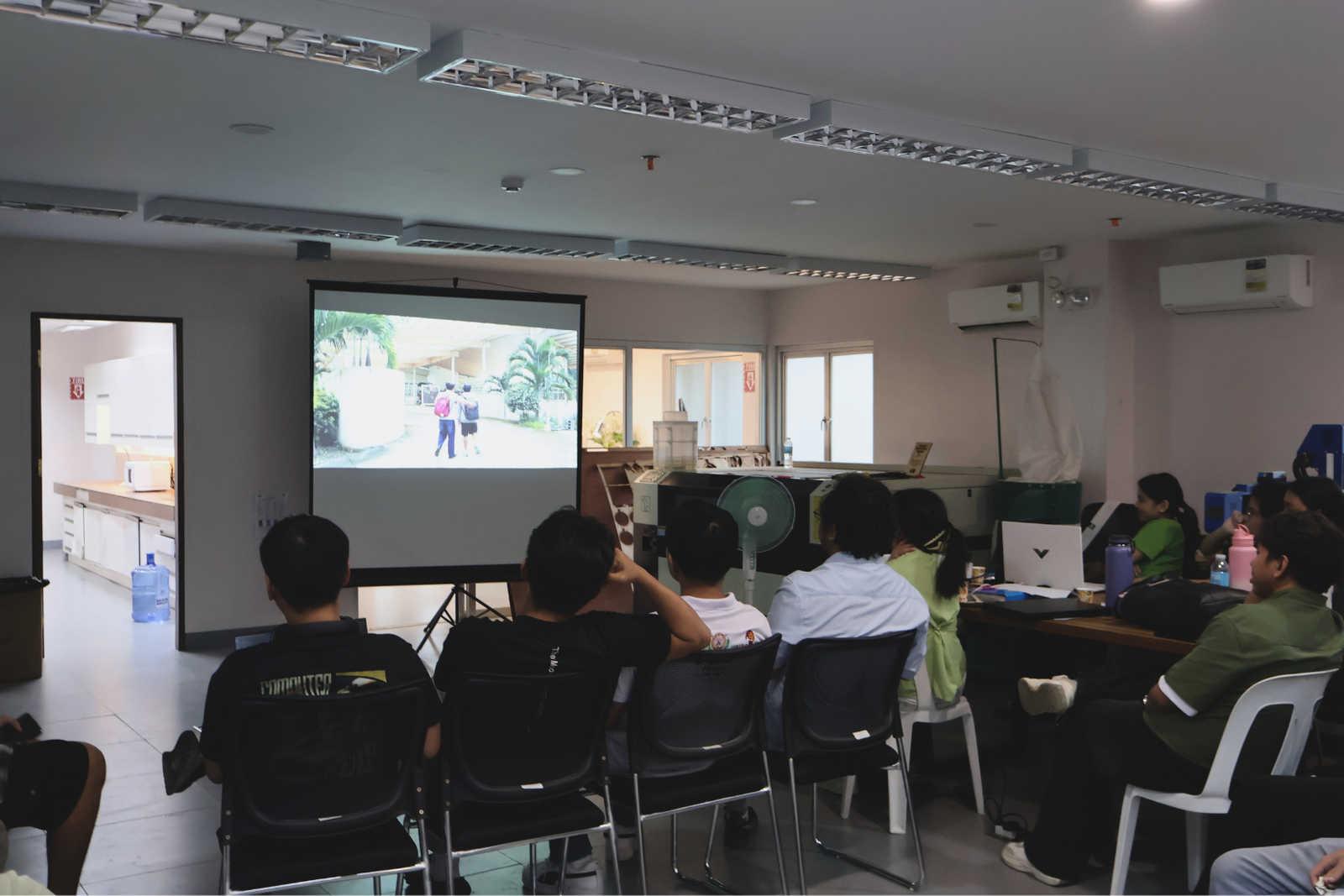 Mentors and interns watching an audio-visual presentation